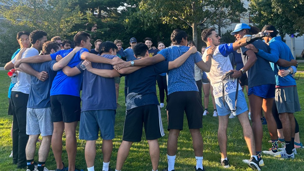 Blue Academy gathers in a huddle