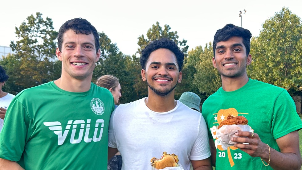 Green Academy poses with their hamburgers and fried chicken sandwiches