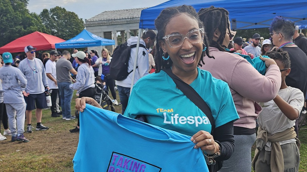 Kelly Holder with a shirt that says "taking bold steps to save lives"