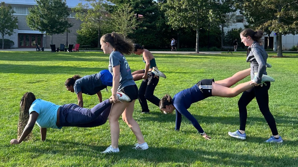 students compete in a wheelbarrow race