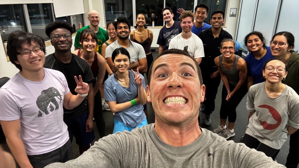 Dean Hampton and Coach Mike Pimentel take a selfie with medical students